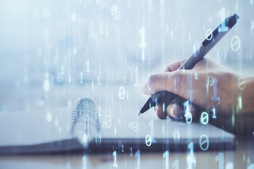 Double exposure of writing hands on background with data solution hologram on front. Technology concept. Close up