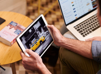Man with tablet with taxi picture.