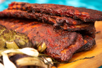 Several slabs of BBQ ribs on a wooden board