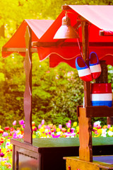 Stand with traditional Holland symbols in national colors taken against sunset light. Blurred colorful tulips in the background. Traditional Dutch wooden clogs. Netherlands, abstract concept, travel