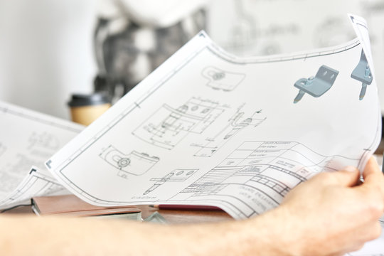 Engineer with blueprint.