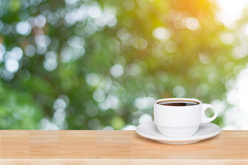 Empty wood table top and coffee cup blur nature background with copy space for display or montage your products