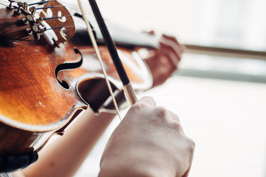 Young girl's hands practicing violin