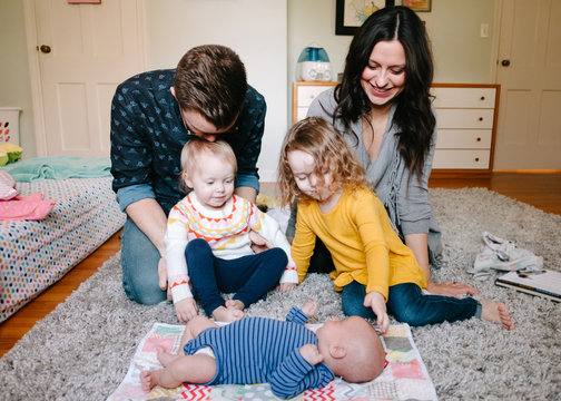 family looks at baby