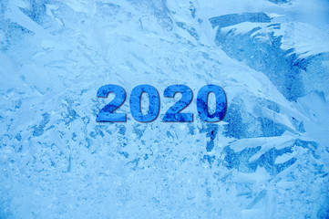 New Year.The inscription of the numbers 2020. Frozen covered with hoarfrost and patterns blue...