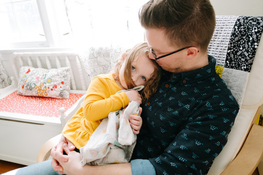 dad comforts daughter in chair