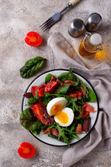 Healthy salad with prosciutto, tomato and egg