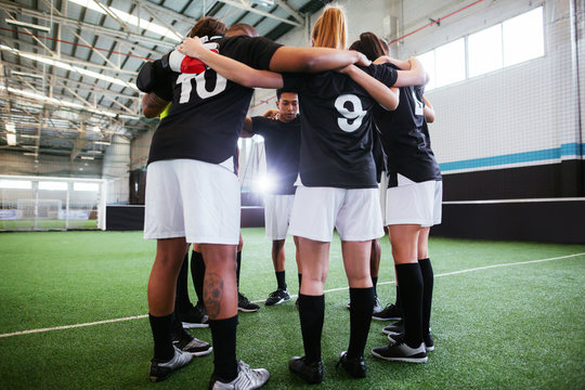 Young soccer players discussing strategy.