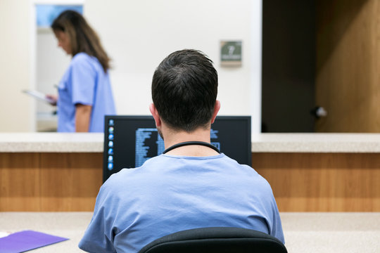 Clinic: Male Nurse Working At Desk