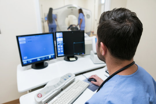 Clinic: Male Tech In Outside Control Room Ready For Scanning