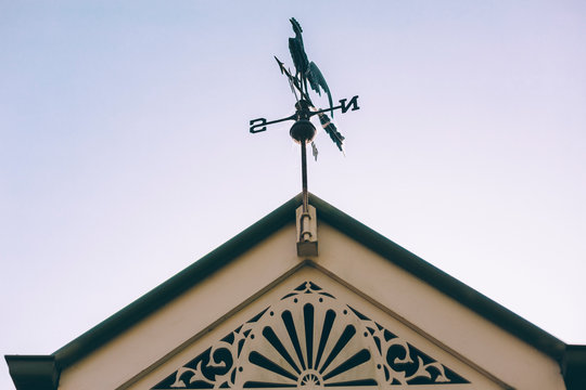 Top of house facade with wind vane