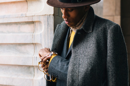 Businessman checking time outdoors - Powered by Adobe