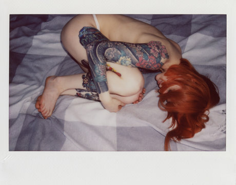 young woman with red hair on the bed