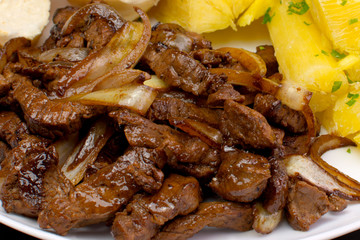 Traditional Brazilian pub food striploin with onions
