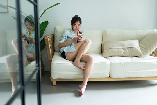 young woman indoor with mobile phone in hand