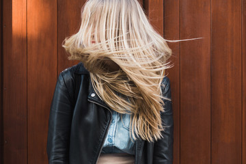 Young blond woman with long hair shaking her head side to side