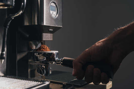 Man grounding coffee for a espresso