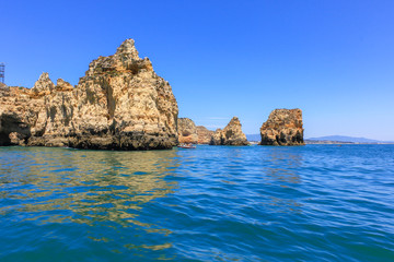 Panoramic landscape view of golden cliffs and emerald water in Ponta da Piedade, Lagos, Algarve, Portugal