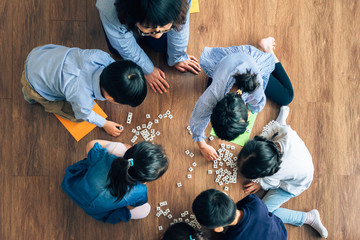 Teacher and preschool kids learning  in classroom