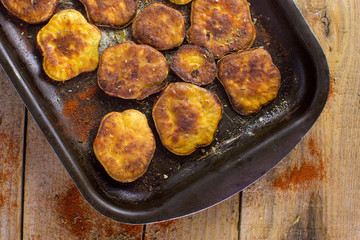 Baked sweet potato seen from above in a rustic wood background