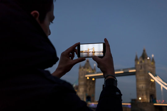 Man taking pictures to the Tower Bridge in London