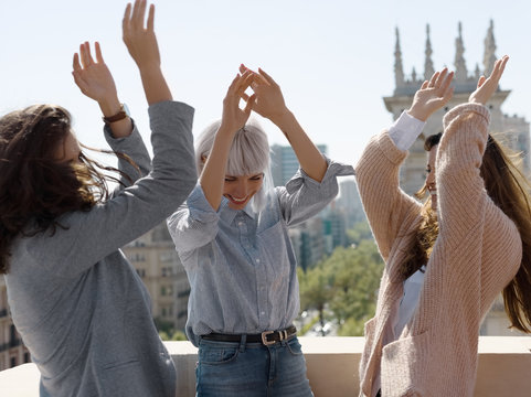 Excited women celebrating on terrace