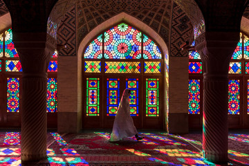 Anonymous woman inside of colorful oriental mosque