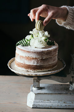 Crop person decorating cake