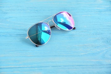 Multicolored aviator eyeglasses with selective focus on blue background. Summer vacation concept...