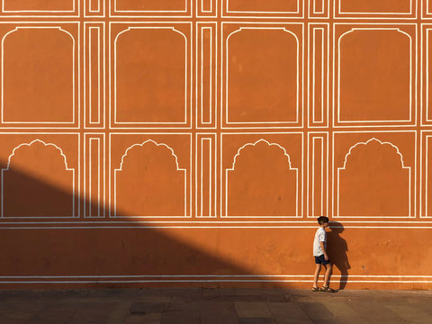 Boy walking next to City Palace walls, Jaipur, Rajasthan, India