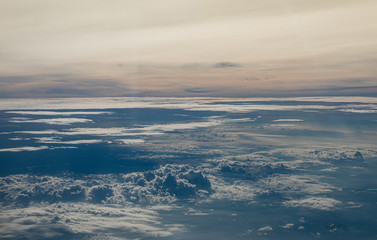 Fototapeta na wymiar Clouds seen from an airplane, blue sunshine, soil background nature landscape