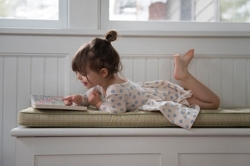 Little girl reading a book