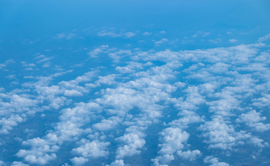 Clouds seen from an airplane, blue sunshine, soil background nature landscape