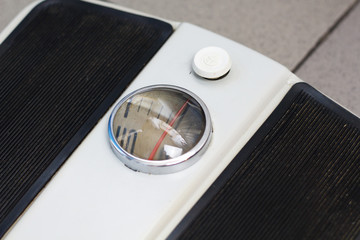 analog mechanical old retro bathroom weight scale on floor on a gray tile close up. Weight control