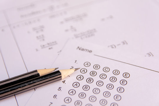 Pencil on answer sheets or Standardized test form with answers bubbled. multiple choice answer sheet .