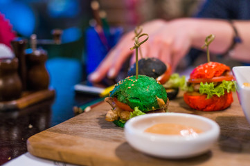three small burgers for children in the restaurant.
