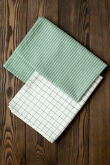 Two kitchen towels for table setting at wooden background