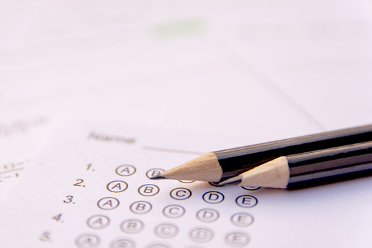 Pencil On Answer Sheets Or Standardized Test Form With Answers Bubbled. Multiple Choice Answer Sheet .