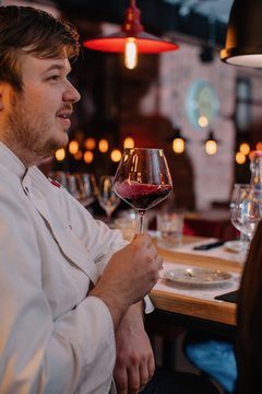 Closeup portrait of man with glass of red wine at restaurant