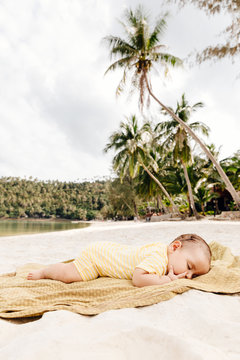 Little girl sleeping on beach