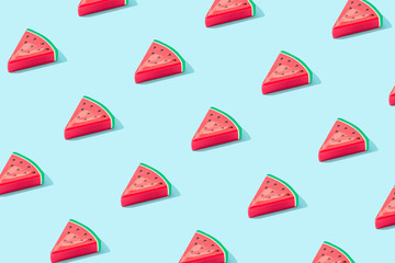 Trendy sunlight Summer pattern made with watermelon fruit on bright light blue background. Minimal summer concept.