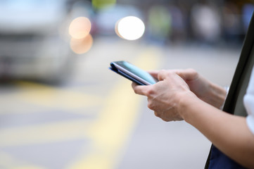 Woman use of mobile phone in city