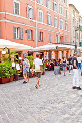 Ancona, Italy - June 8 2019: People enjoying summer day and food at outdoor restaurant and resting.