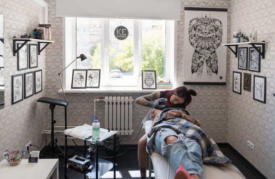 Artist tattooing client in studio