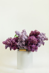 Awesome purple bouquet of lilac flowers in a stylish vase on a white background
