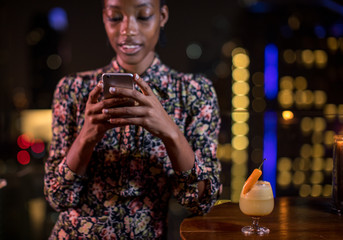 Woman smiling while using her phone
