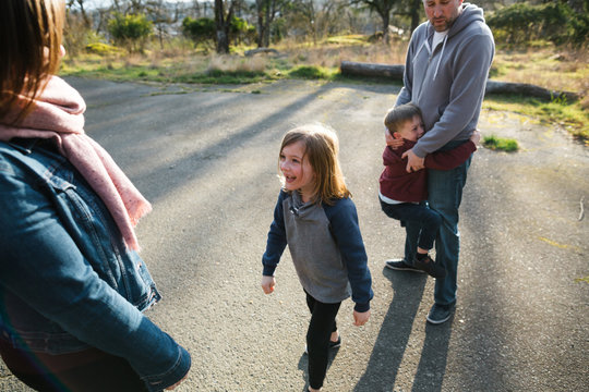 Fun family of four spending time together in nature