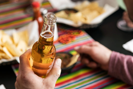 Cinco: Anonymous Man Holding Bottle Of Cerveza