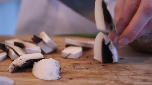 master chef cutting mushrooms close up