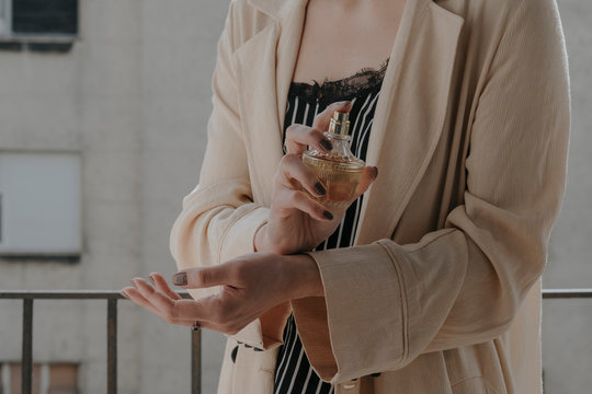 Anonymous female model using parfume